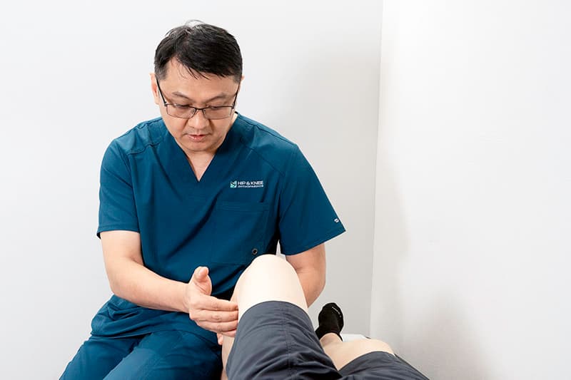 Dr Adrian Lau assessing ACL tear injury